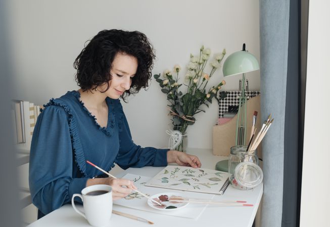 Woman painter working at home