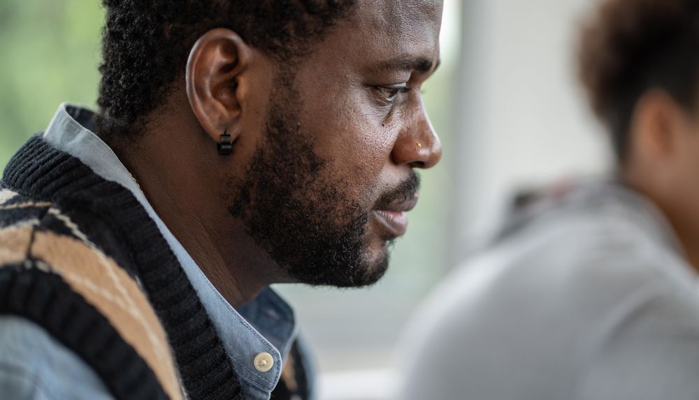 Portrait of male teacher looking down in classroom
