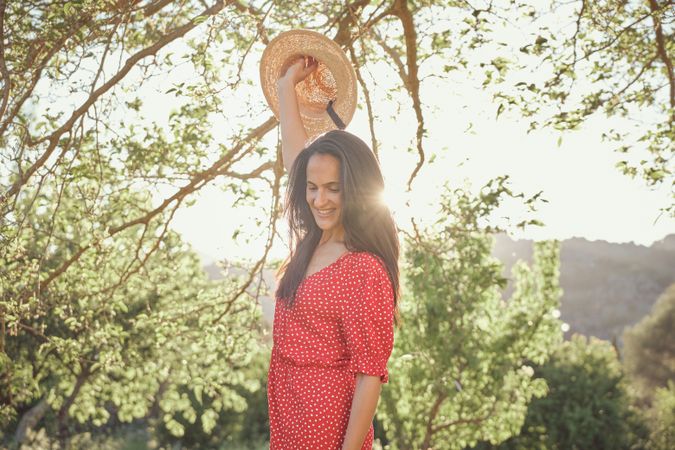 Smiling woman in summer dress in park