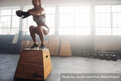 Shot of a young woman jumping onto a box as part of exercise routine 5wLER4