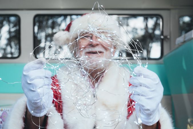 Santa Claus sitting with gifts and garland