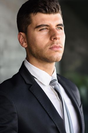 Portrait of serious man with blue eyes in suit and tie
