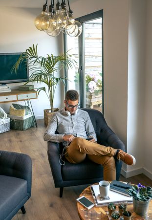 Man sitting in an armchair with tablet