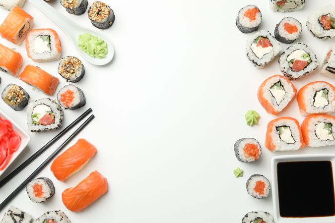 Sushi rolls and chopsticks on light background, space for text. Japanese food