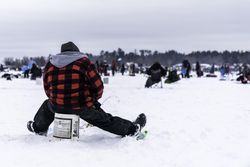 Nisswa, MN, USA - January 25th, 2020: Back shot of a male angler ice fishing