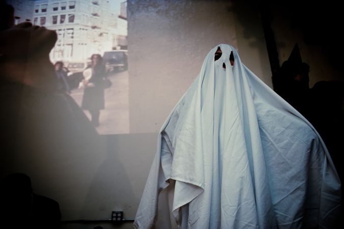 Person in sheet ghost costume