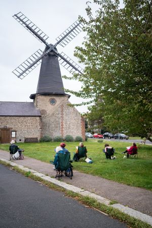 Group of people sitting drawing windmill in art class