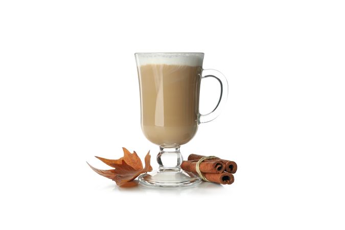 Glass cup of latte isolated on neutral background