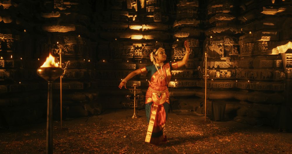 Portrait of an Active Indian Woman Engages in a Spellbinding Performance of Traditional Folk Dance Inside a Candle-Lit Temple.