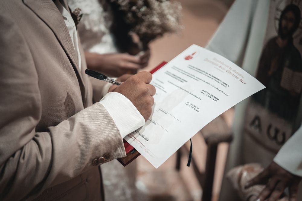 Man in gray suit signing a contract