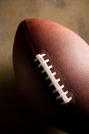 American football ball on dark background