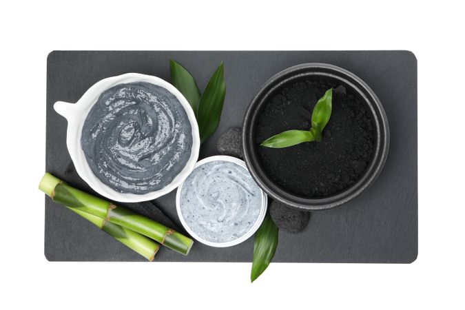 Fresh bamboo shoots with charcoal in the form of a paste, isolated on plain background