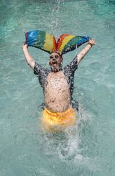 Excited gay man in swimming pool