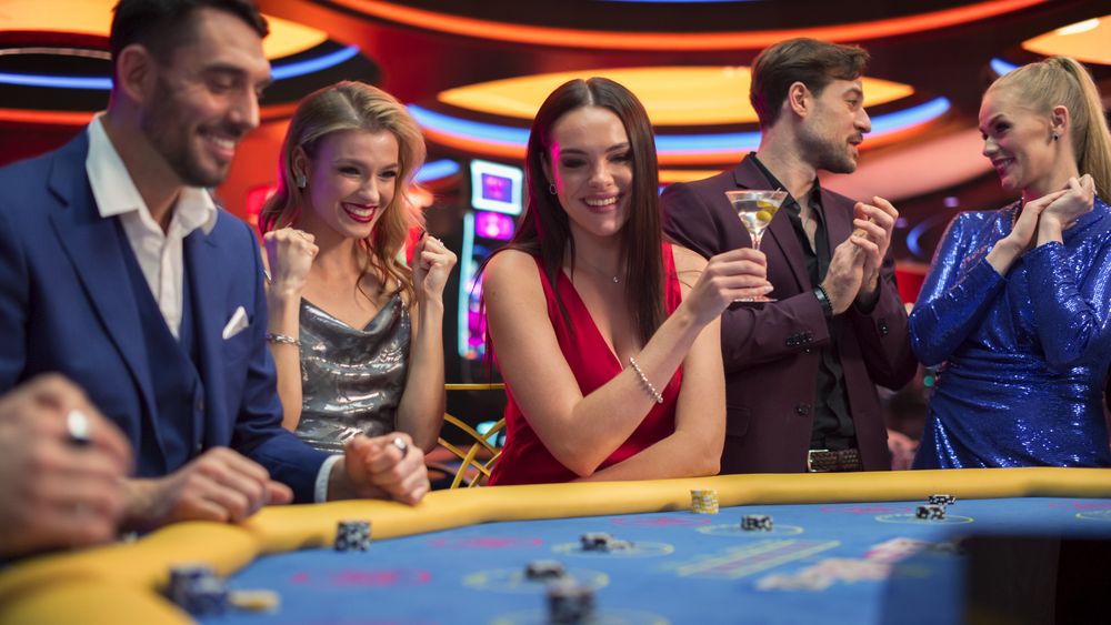 Glamorous Guests Placing Cool Bets while Playing Baccarat.
