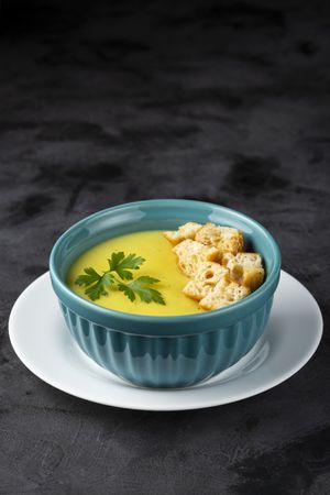Bowl with onion soup and croutons on the table.