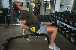Strong man exercising with dumbbells in gym