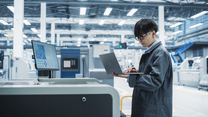 Asian man with computer at electronics store check out