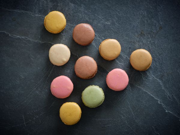 Pyramid of tasty macaroons on table