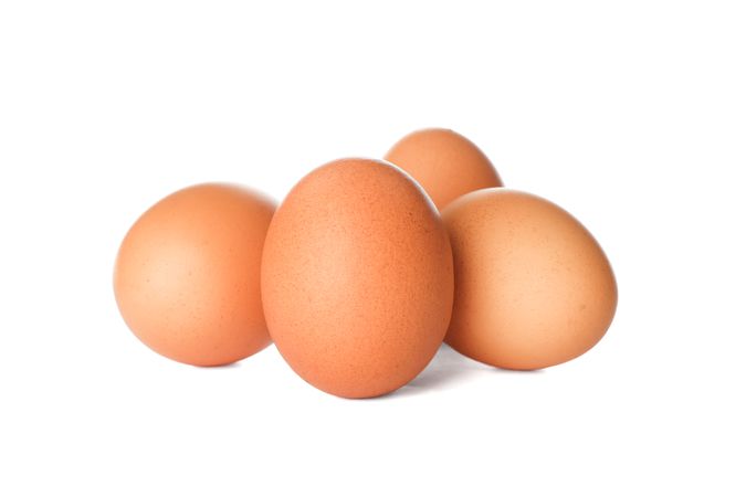 Few raw chicken eggs on plain background