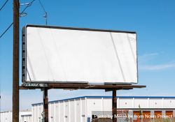 Billboard mockup in industrial area of town on nice day with clear sky 0L9kV5