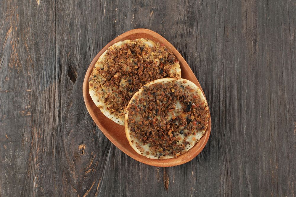 Surabi oncom, Indonesian pancake with fermented soybean on wooden table