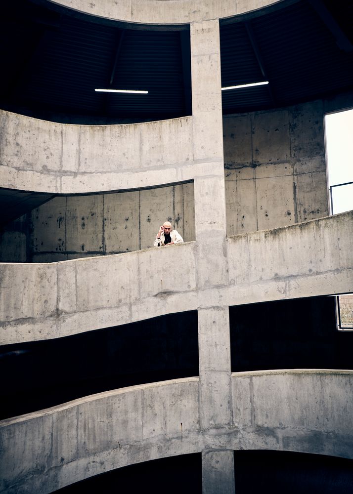Young man posing on spiral parking structure
