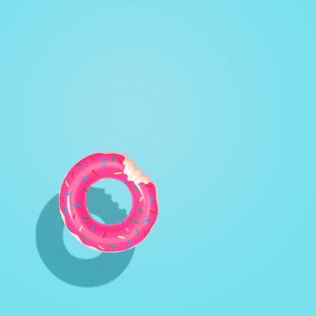 Top down aerial view of summer float donut inflatable toy in pool