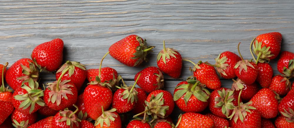 Tasty strawberry on wooden background, top view. Summer berry
