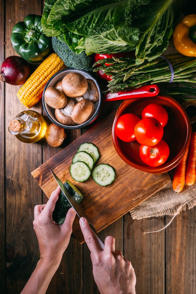 Vegetables and utensils on kitchen table