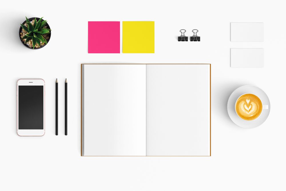 Modern workspace with coffee cup, smartphone, paper, notebook, tablet copy space