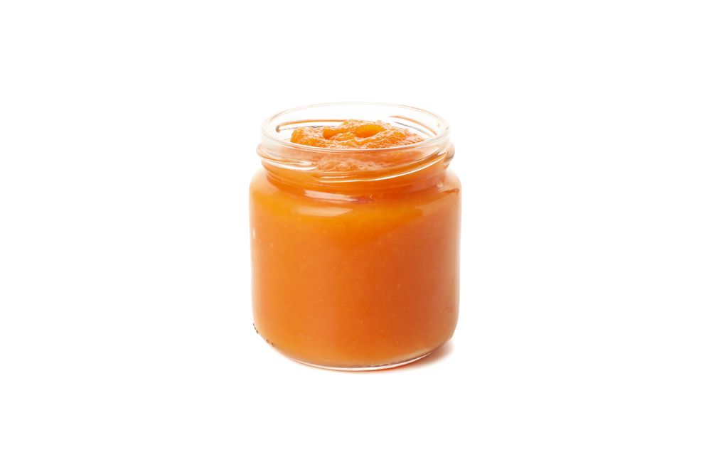 Glass jar with healthy baby food isolated on plain background
