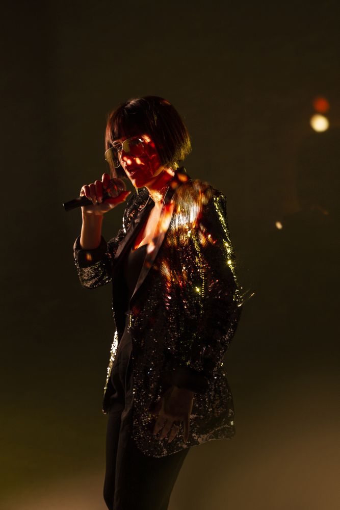 Stylish woman singing on stage