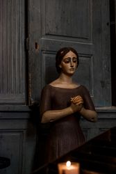 Religious statue with candle