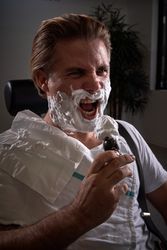 Man with foamy beard pretending to sing