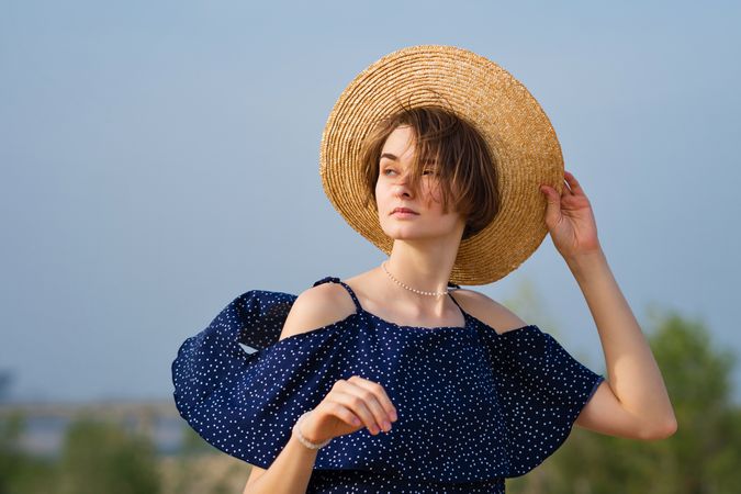 Young woman in straw hat outdoors