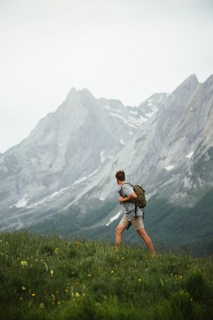 Unrecognizable man with backpack hiking in Pyrenees mountains