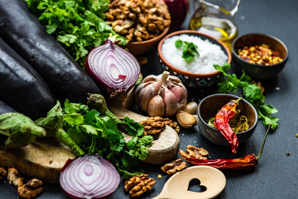 Ingredients for cooking eggplant dish on rustic background