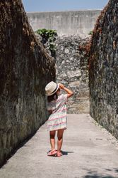 Girl in narrow stone walkway