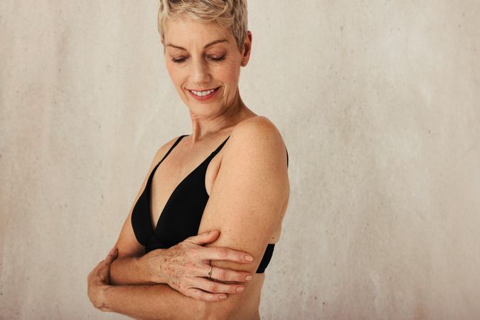 Mature woman going embracing her natural and aging body