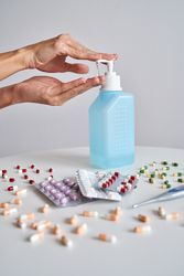 Anonymous person pumping antiseptic into hand