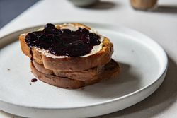 Brioche with butter and jam on top