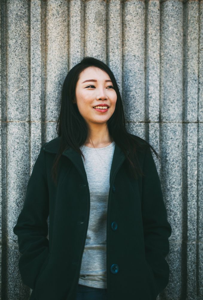 Asian woman near marble wall