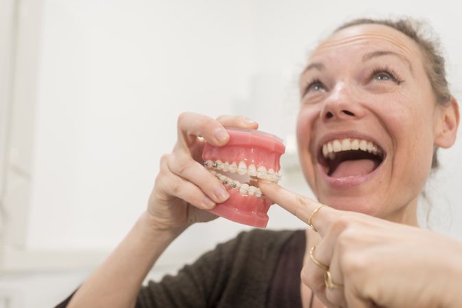 Woman playing with jaws in dentist clinic