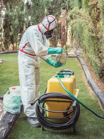 Fumigation specialist putting package into yellow device