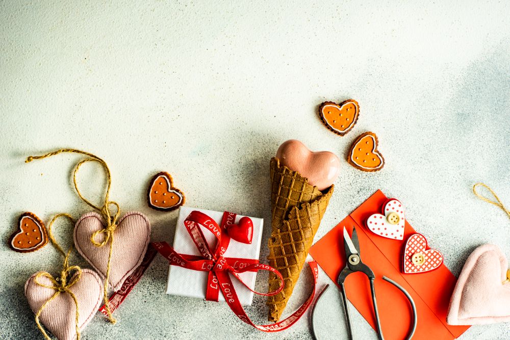 Heart ornaments and gift on grey background