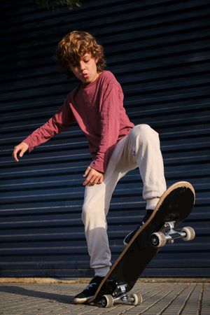 Boy practicing skateboard riding on street