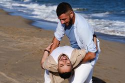 Happy gay couple dancing on seaside