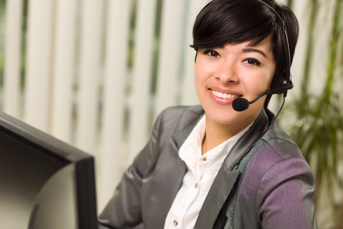 Young Woman Smiles Wearing Headset