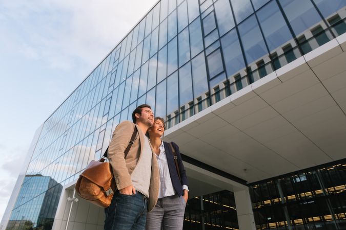 Businesspeople couple outside contemporary building