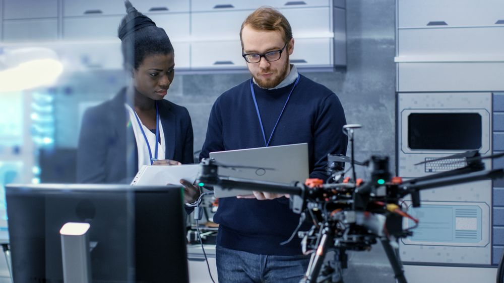 Male and Female Engineers Working on a Drone Project